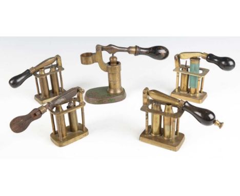 A group of four various late19th century brass cartridge redecapping tools, each with pillar frame assembly and swing-over hi