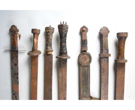 A collection of seven late 19th century Tibetan swords with part and full-fullered steel blades, length of longest blade 84cm