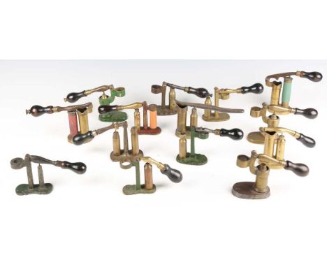 A group of fourteen various European cartridge redecapping tools, including 12, 20 and .410 bores, with cast brass and steel 