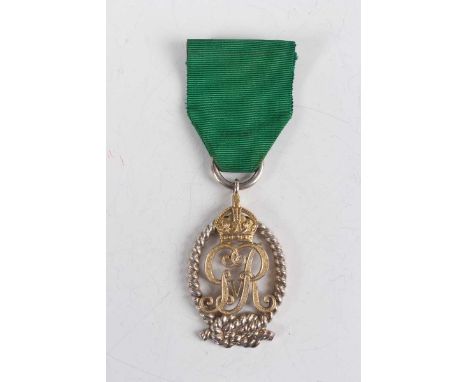 A Royal Naval Reserve decoration, George V issue, London 1922 by Garrard &amp; Co Ltd, unnamed as issued, with ribbon brooch.
