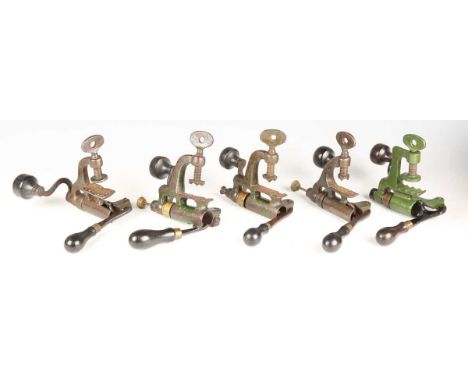 A group of five late 19th century roll turnover cartridge reloading tools by James Dixon &amp; Sons, comprising four 12-bore 
