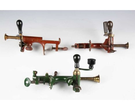 A group of three lacquered brass mounted painted steel combination cartridge loading tools, comprising a red/brown painted 20