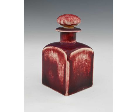 Ruskin Pottery, a High Fired scent bottle, circa 1920s, cuboid form with bun stopper, red sang de boeuf glaze, impressed mark