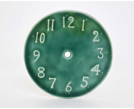 Ruskin Pottery, a Souffle glazed clock face, relief moulded with Arabic numerals, green glaze, unmarked, 12.5cm diameter