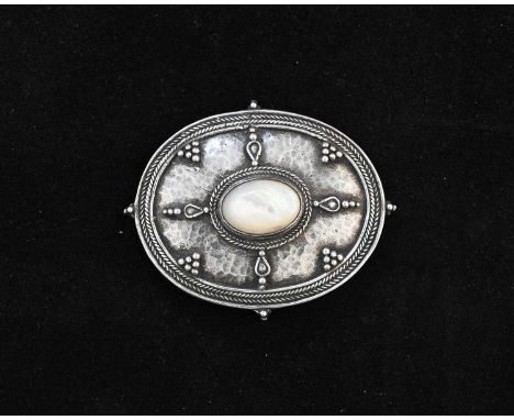 An Arts and Crafts silver and mother of pearl brooch, in the style of Edward Spencer for the Artificers Guild, oval form, app