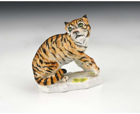 A Meissen figure of a tiger, 20th century, model 1471, underglaze blue mark and stamped numbers, 6.5cm high