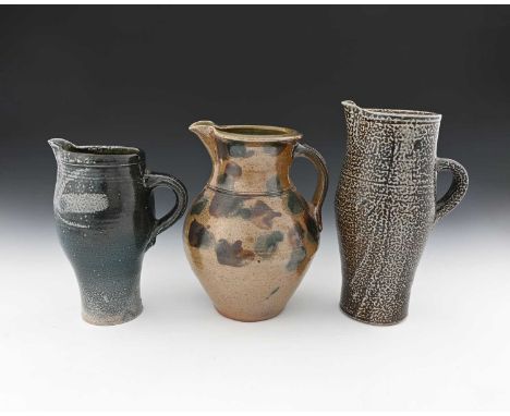 Michael Casson, three studio pottery salt glazed stoneware jugs, obe of slender elongated barrel form, brown glazed, another 