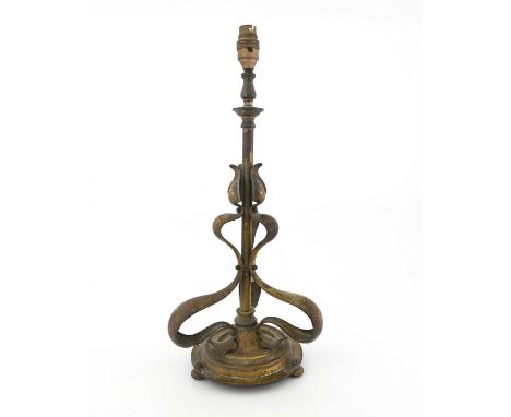 An Arts and Crafts gilt brass table lamp, in the style of Jesson, Birkett and Co., the tubular upright with three applied whi