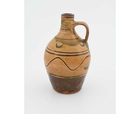 Michael Cardew for Winchcombe, a studio pottery flagon, early 20th century, shouldered form, slip glazed and sgraffito decora