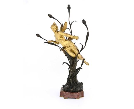 Gustavo Obiols, an Art Nouveau bronze figural lamp, modelled as a gilt fairy supported within a four branched reed, on a cant