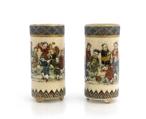A pair of Japanese Satsuma miniature vases, of cylindrical brush pot form, painted in the round with boys playing, between po