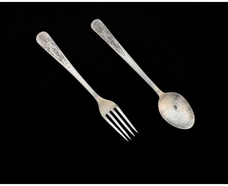 An Arts and Crafts silver christening or childs spoon and fork set, planished, the terminals chased with serpentine foliate c