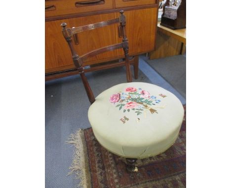 A late 19th century mahogany framed nursing chair with embroidered seat and ceramic castors 