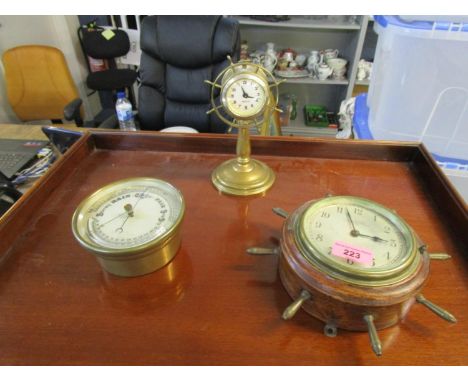 An early 20th century cased and brass wall clock in the form of a ships wheel, the silvered dial with Arabic numerals, marked