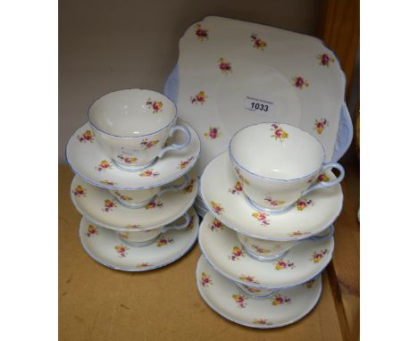 A Shelley tea set for six comprising cake plate, side plates, cups and saucers, decorated with flower sprays and pale blue ha