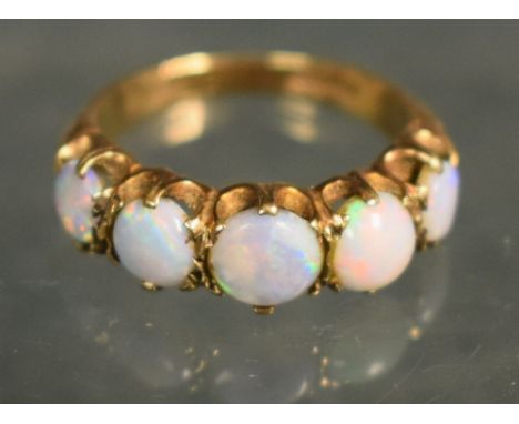 A five stone opal ring, each graduating circular cabochon opal flashing green, orange, red, blue and violet colour play, 9ct 