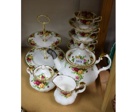 A Royal Albert Old Country Roses part tea service comprising tea pot, milk, sugar, cake stand and four cups and saucers