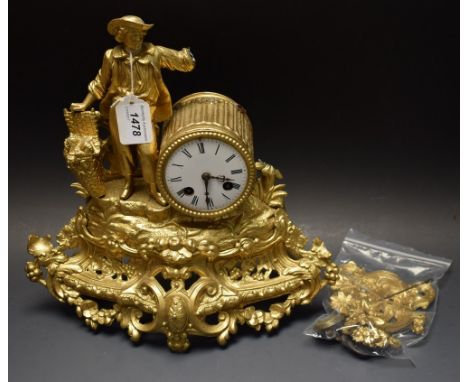 A late 19th century French spelter mantel clock, mounted with a gentleman harvesting grapes, gold painted, key
