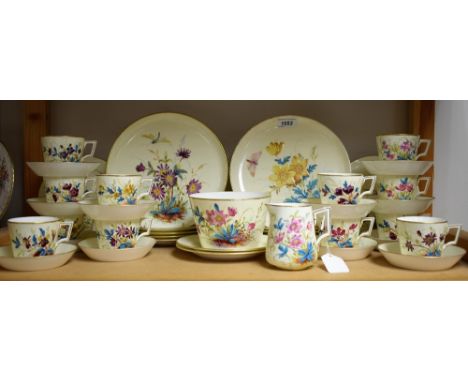 A Derby Crown Porcelain tea service, comprising twelve teacups, saucers, two bread and butter plates, sugar bowl and cream ju