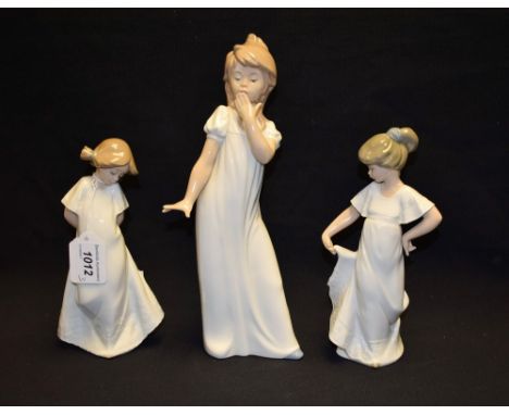 A Nao ceramic figure, Girl Yawning in Nightgown; others, Shy Girl in Nightgown, How Pretty (3)