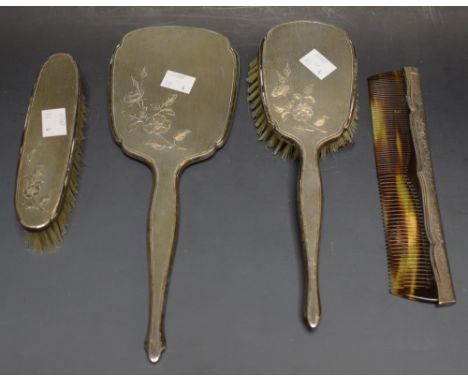 A silver three piece vanity set, Birmingham 1964; a silver mounted comb (4)