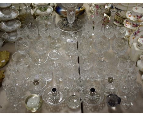 A large quantity of cut crystal, some Tutbury, to include brandy bowls, wine glasses, tumbler, champagne, silver plated toppe