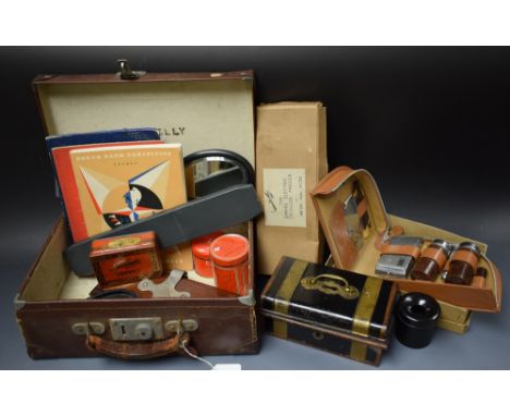 A brown leather case; a metal cash box; a gentleman's vanity case; an ebonised hand mirror, hair tidy and pin tray; a slide r