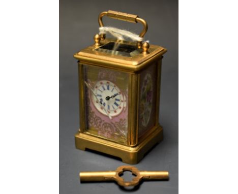 A  French miniature gilt brass carriage clock, the porcelain panels painted with flowers on a rose pompadour ground, swing ha