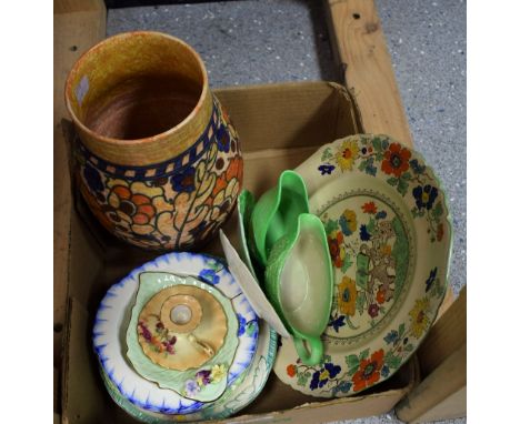 A Charlotte Rhead tube lined ovoid vase, applied with a band of flowers and foliage in blue and orange on a mottled ochre gro