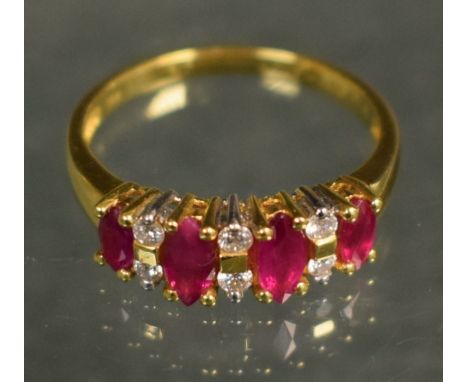 A diamond and ruby dress ring, set with four navette pinky red rubies, each divided by a pair of diamond accents, total estim