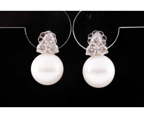 A pair of diamond and South Sea peal earrings, the mounts set with three round brilliant-cut diamonds above a South Sea pearl