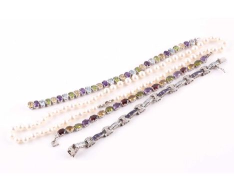 A multi gem-set bracelet, composed of oval cut garnets, amethysts, citrine and peridots horizontally set in claw set white me