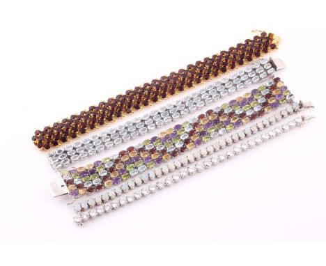 An articulated garnet set gilded bracelet, the claw set circular stones in diagonal rows to a concealed push-button clasp mar