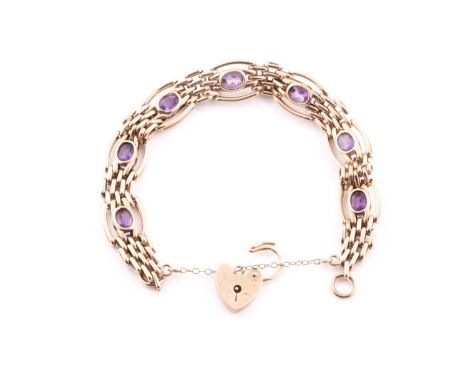 A 9ct yellow gold gate-link bracelet, the articultated links with bezel-set mixed oval-cut amethysts, the heart-shaped clasp 