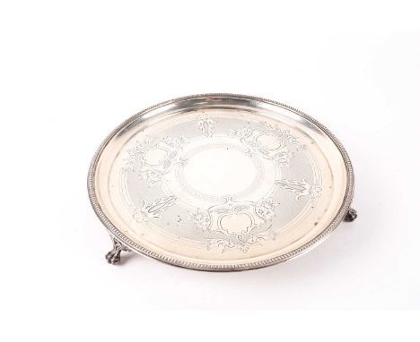 A Victorian circular silver waiter. London 1867 by Hukin &amp; Heath. With engraved and engine turned decoration. Supported o