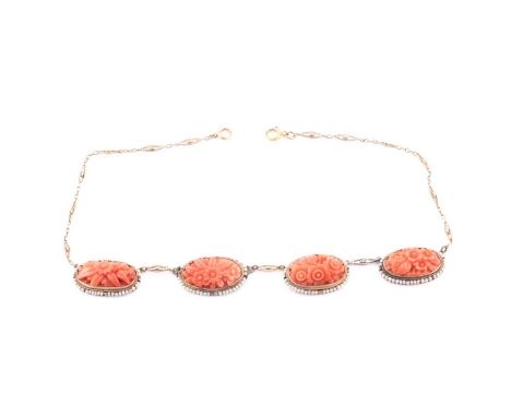 A late 19th / early 20th century coral and seed pearl necklace, set with four carved coral segments with floral designs, each