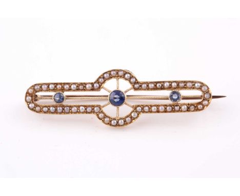 An Edwardian yellow metal sapphire and seed pearl brooch, set with three round rose-cut sapphires, within a shaped rectangula