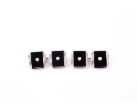 A pair of 9 carat white gold, onyx, and pearl cufflinks, with cross-hatched borders around square black onyx plaques centered