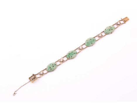 A jade and seed pearl bracelet; comprising four oval carved jade panels set between five foliate pearl set spacers on a doubl