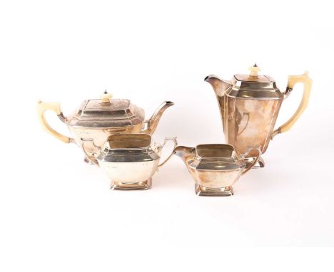 An Art Deco silver four-piece tea set. Sheffield 1936 by Frank Cobb &amp; Co Ltd. The moulded panelled form with ivory handle