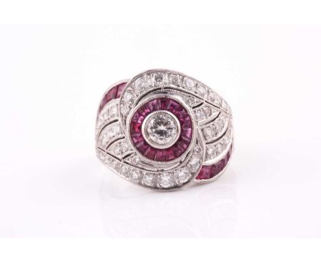 A French mid century diamond and ruby ring, centred with a round-cut diamond of approximately 0.22 carats, within a calibre b