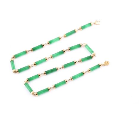 A yellow metal and green jade necklace, with smooth elongated jade segments with yellow metal terminals, the clasp marked 14K