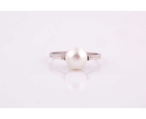 A natural saltwater pearl ring, the pearl measuring 7.5 x 7.4 x 6.8 mm, mounted in unmarked white metal, size K 1/2.Together 