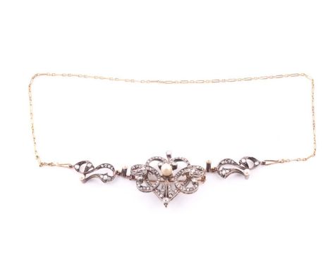 An Edwardian diamond and pearl yellow metal necklace/brooch, the central brooch of heart form flanked by "C" scrolls set with