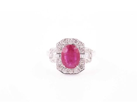 An 18ct white gold, diamond, and ruby cocktail ring, set with a mixed oval-cut ruby of approximately 2.0 carats, the chamfere