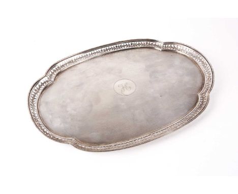 An early 20th-century lobed oval silver dressing table tray. Birmingham 1938 retailed by Beaver of Manchester. With decorativ