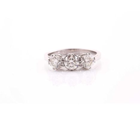 A platinum and diamond ring, set with three round brilliant-cut diamonds of approximately 1.20 carats combined, approximate c