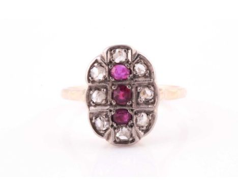 An 18ct yellow gold, diamond, and ruby ring, the oval mount inset with mixed rose-cut diamonds and three old-cut rubies, moun