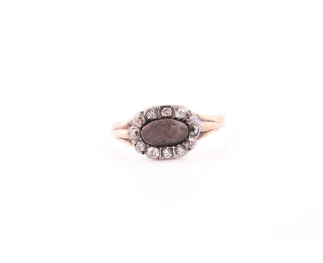 A 19th century yellow metal and diamond ring, centred with a small glass section inset with plaited hair, unmarked, size K 1/