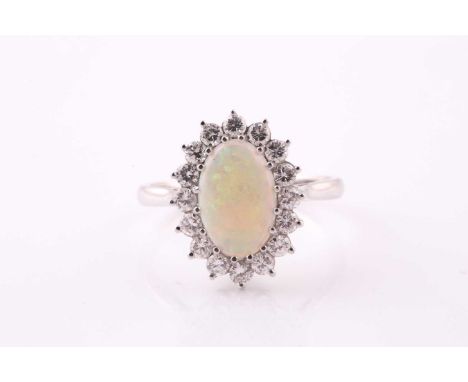 An opal and diamond cluster ring; the claw-mounted opal within a border of sixteen round brilliant cut diamonds in a basket m